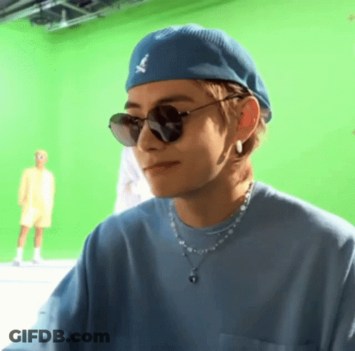 A Close Up Of A Person Wearing Sunglasses And A Blue Hat . GIF