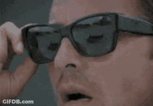 A Close Up Of A Person Wearing Sunglasses And A Pair Of Headphones . GIF
