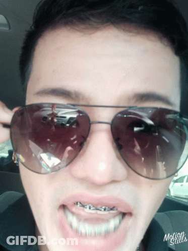 A Close Up Of A Person Wearing Sunglasses With Motion Stills Written On The Bottom Left GIF