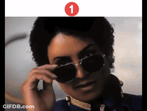 A Close Up Of A Person Wearing Sunglasses With The Number 1 On The Bottom GIF