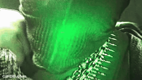 A Close Up Of A Person With A Green Background GIF