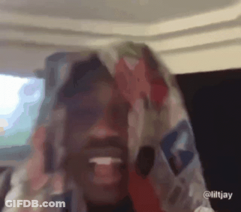 A Close Up Of A Person With A Scarf On Their Head GIF