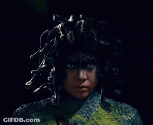 A Close Up Of A Person With A Snake Costume GIF