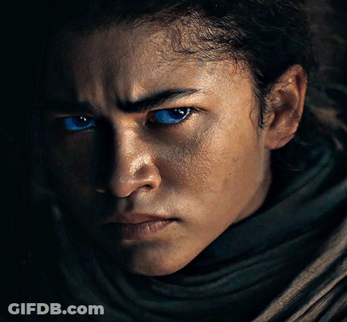 A Close Up Of A Person With Blue Eyes GIF