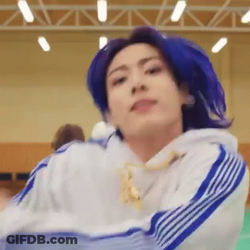 A Close Up Of A Person With Blue Hair Wearing A White And Blue Sweatshirt . GIF