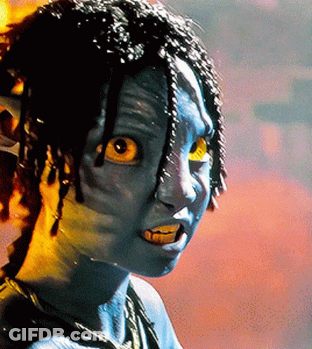 A Close Up Of A Person With Blue Paint On Their Face And Yellow Eyes GIF