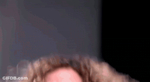 A Close Up Of A Person With Curly Hair GIF