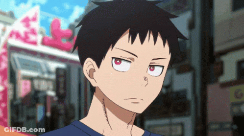 A Close Up Of A Person With Red Eyes And A Blue Shirt GIF