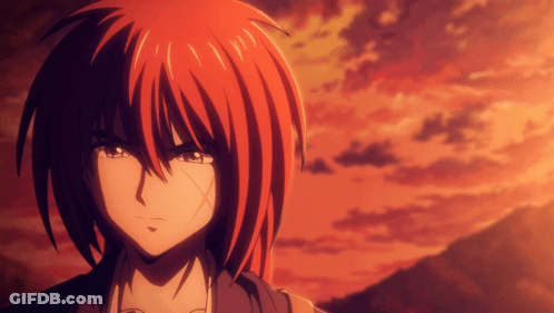 A Close Up Of A Person With Red Hair And A Sunset In The Background GIF
