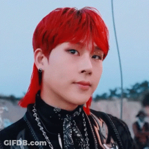 A Close Up Of A Person With Red Hair Wearing A Black Shirt And A Bandana . GIF