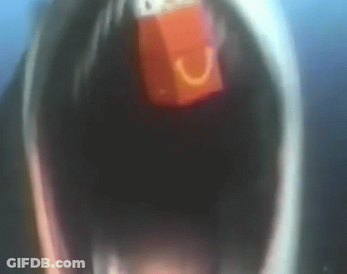 A Close Up Of A Person With Their Mouth Open And A Red Object In It GIF
