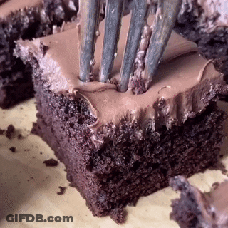 A Close Up Of A Piece Of Chocolate Cake With A Fork Sticking Out Of It GIF