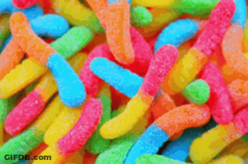 A Close Up Of A Pile Of Colorful Gummy Worms GIF