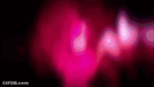 A Close Up Of A Pink Glowing Object With A Black Background GIF