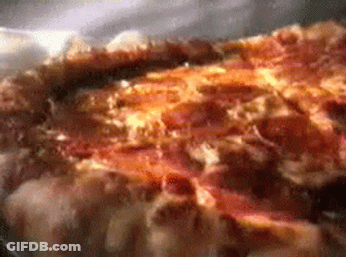 A Close Up Of A Pizza With A Lot Of Cheese GIF