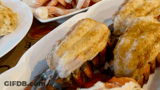 A Close Up Of A Plate Of Food On A Table With Shrimp . GIF