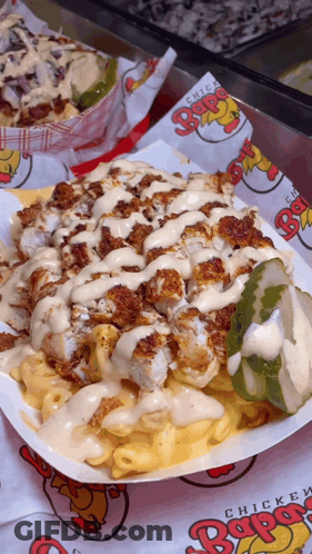 A Close Up Of A Plate Of Food With Chicken And Macaroni Cheese GIF