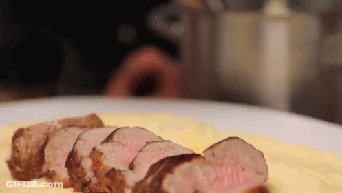 A Close Up Of A Plate Of Food With Meat And Mashed Potatoes GIF