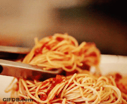 A Close Up Of A Plate Of Spaghetti With Sauce GIF