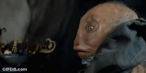 A Close Up Of A Puppet With A Beard Looking At Something GIF