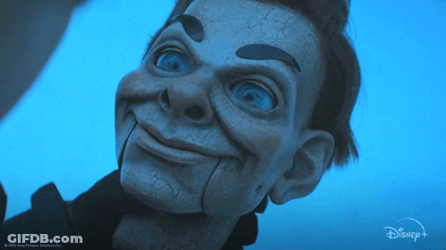 A Close Up Of A Puppet With A Disney Logo In The Background GIF