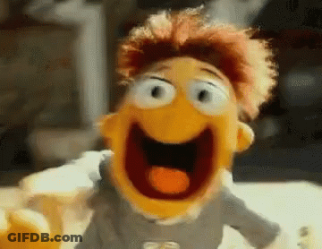 A Close Up Of A Puppet With Its Mouth Open And A Tongue Sticking Out . GIF