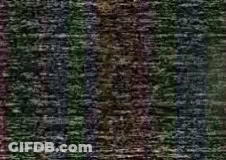 A Close Up Of A Purple And Green Striped Fabric GIF