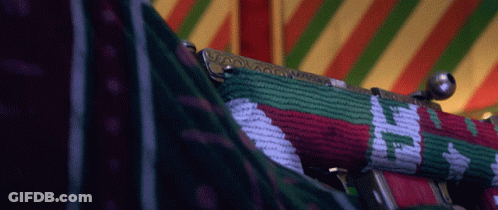 A Close Up Of A Purse With A Red Green And White Pattern On It GIF