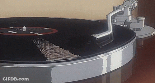 A Close Up Of A Record Player Playing A Record On A Table . GIF