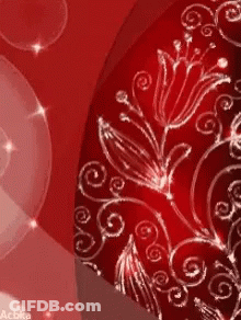 A Close Up Of A Red Background With Flowers And Swirls On It GIF