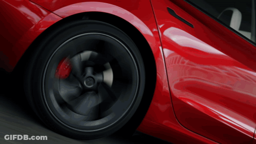 A Close Up Of A Red Car 'S Wheel With A Black Rim GIF