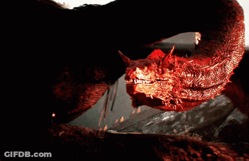 A Close Up Of A Red Dragon With Sharp Teeth Looking At The Camera GIF