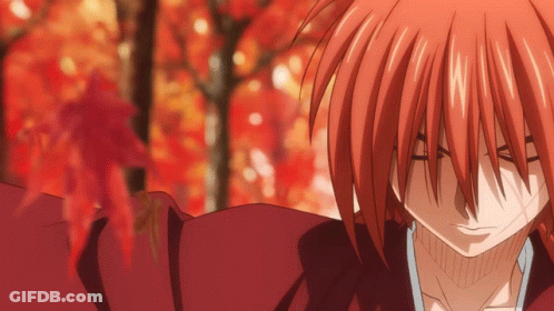 A Close Up Of A Red Haired Anime Character With A Blurred Background GIF