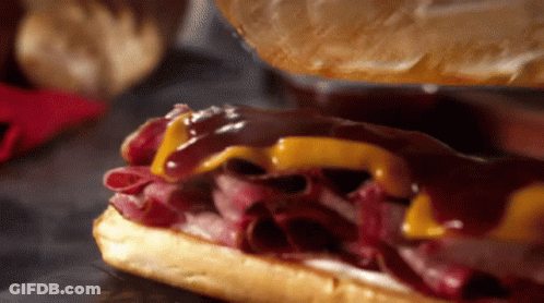 A Close Up Of A Roast Beef Sandwich With Cheese GIF