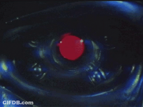 A Close Up Of A Robot Eye With A Red Center GIF