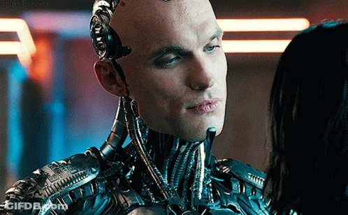 A Close Up Of A Robot Looking At A Woman 'S Face With A Caption That Says ' Stark Beyond ' GIF