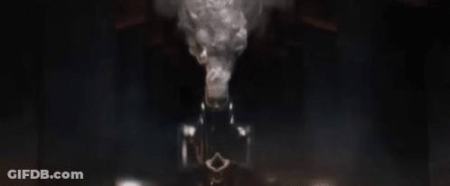 A Close Up Of A Robot 'S Face In A Dark Room Looking At The Camera . GIF