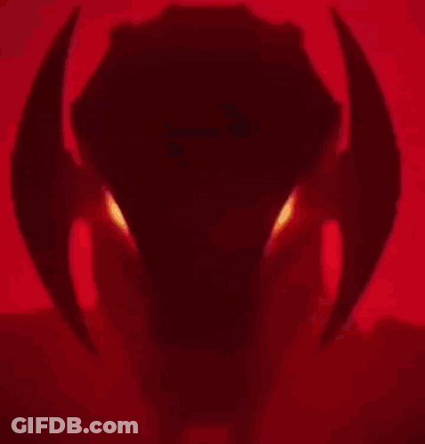 A Close Up Of A Robot 'S Head With Red Eyes . GIF