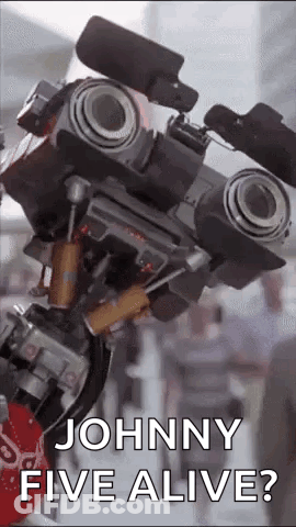 A Close Up Of A Robot That Says `` Johnny Five Alive '' . GIF