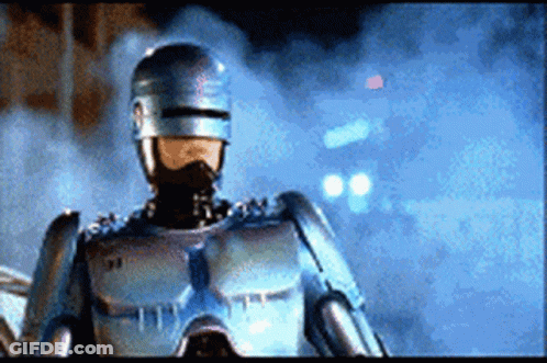 A Close Up Of A Robot Wearing A Helmet And Goggles GIF