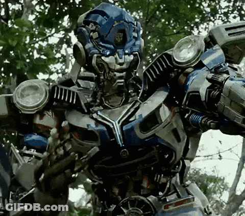 A Close Up Of A Robot With A Helmet On Standing In A Forest . GIF