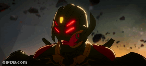 A Close Up Of A Robot With Red Lights On His Eyes GIF
