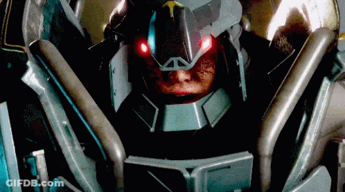 A Close Up Of A Robot With Red Lights On Its Eyes GIF