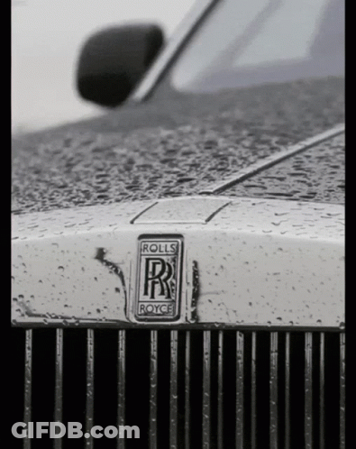 A Close Up Of A Rolls Royce Emblem On The Front Of A Car GIF