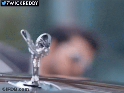 A Close Up Of A Rolls Royce Emblem With 7Wickreddy In The Corner GIF