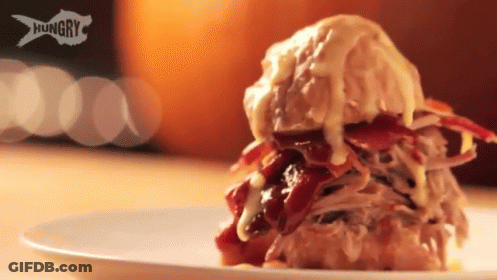 A Close Up Of A Sandwich On A White Plate With The Word Hungry On It GIF