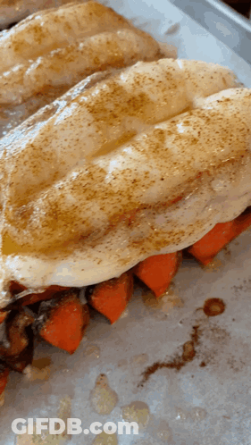 A Close Up Of A Sandwich With Carrots On A Tray GIF