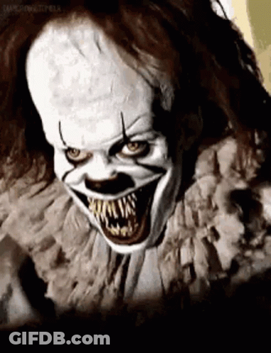 A Close Up Of A Scary Clown With Big Teeth . GIF
