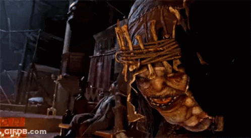 A Close Up Of A Scary Looking Monster With A Rope Around His Head . GIF