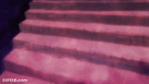 A Close Up Of A Set Of Pink Stairs With A Purple Background . GIF